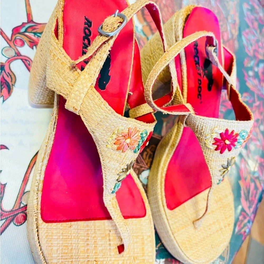 Rocket Dog brand wedges sandals with raffia uppers and floral embellishments.